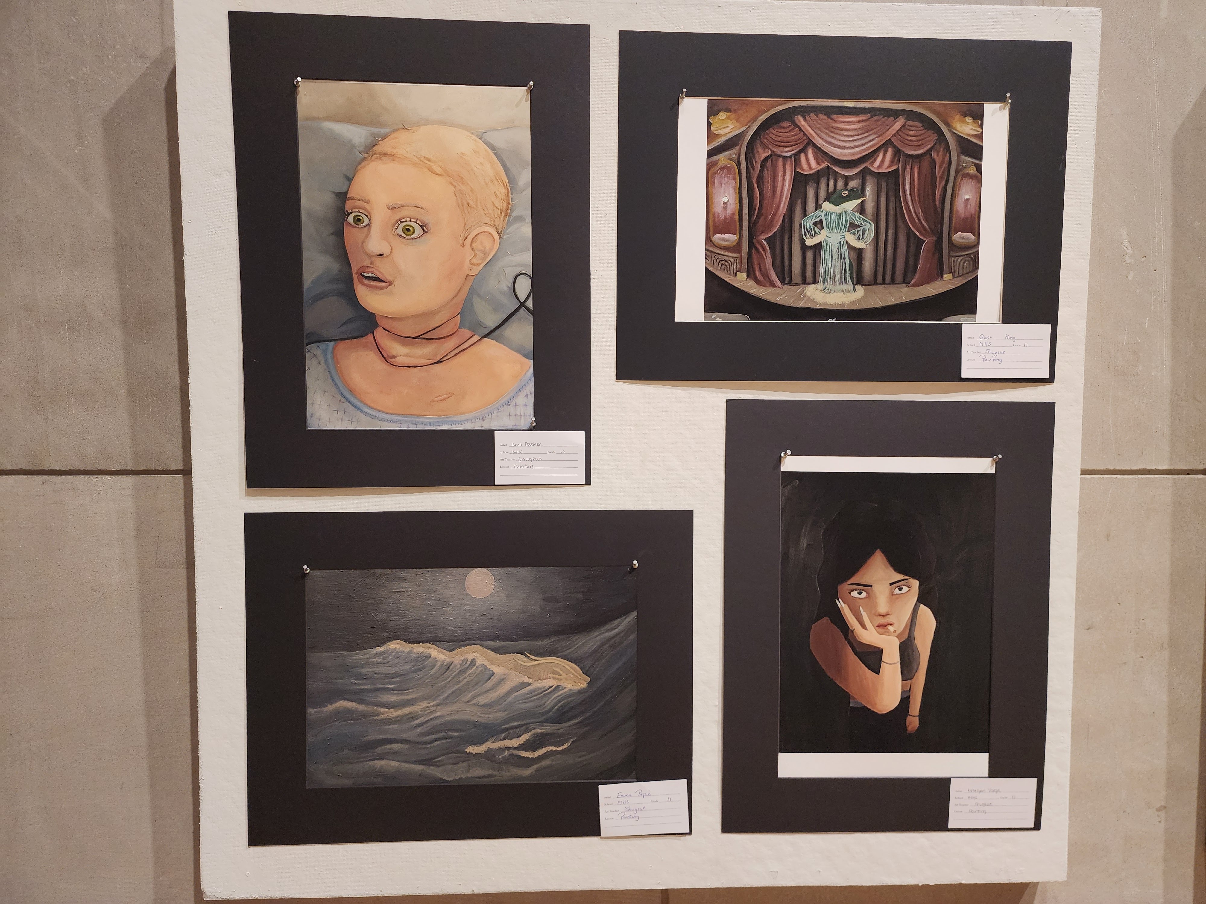 Hand drawn pieces of artwork on display at the gallery, featuring two human images, and two scenery images
